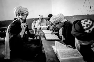 Afghan boys attend their Quran study sessions at the Islami Noor religious school in Kandahar, Afghanistan.