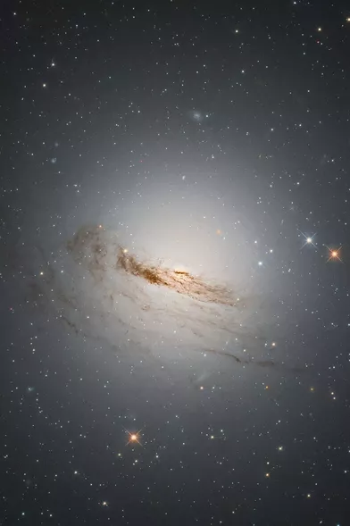15 mars.Hubble présente &quot;GC 1947&quot;, une galaxie lenticulaire située dans la constellation de la Dorade à environ 50 millions d'années-lumière de la Voie lactée. Elle arboreune forme entre spirale et elliptique car elle a perdu presque tout le gaz et la poussière de ses bras en spirale caractéristiques, qui tournaient avant autour de son centre.