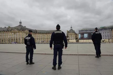 Des policiers devant une place de la Bourse vide, à Bordeaux