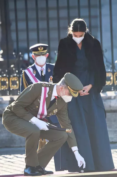 Le roi Felipe VI d'Espagne ramasse la broche de la reine Letiziaqui était tombée par terre, à Madrid le 6 janvier 2022