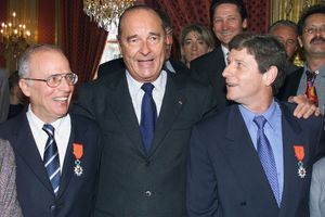 Jacques Chirac félicite Thierry Roland et Jean-Michel Larqué lors de la remise de la croix de chevalier de la légion d'honneur en 2000.