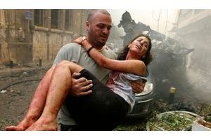  A wounded woman is carried at the site of an explosion in Ashrafieh, central Beirut, October 19, 2012.