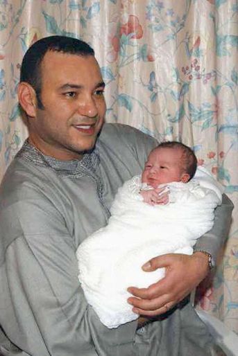 Le prince Moulay El Hassan du Maroc, le 8 mai 2003, jour de sa naissance, dans les bras de son père le roi Mohammed VI