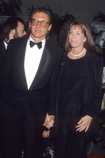 Harrison Ford et sa femme Melissa lors d'un gala organisé par les studios Warner Bros. En 1990. 