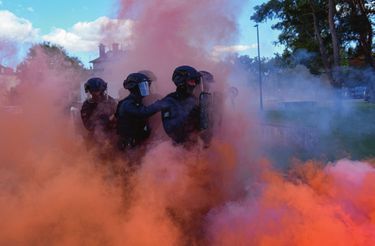 À l’exercice. Reprise de barricade lors d’une manifestation. Dans les fumigènes et les gaz lacrymogènes, un groupe de six hommes.