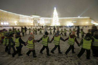 Des enfants exécutent une danse sur la place du Palais décoré avant le Nouvel An et la saison de Noël dans le centre de Saint-Pétersbourg.