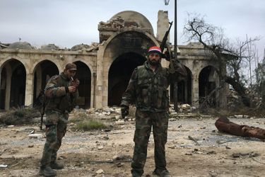 Des soldats syriens posent dans les ruines d'un PC rebelle repris près de la citadelle d'Alep