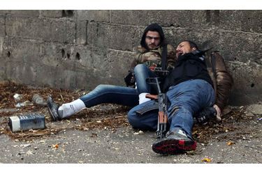 Des combattant de l'Armée syrienne libre essayent d'éviter des balles provenant de tireurs embusqués au cours de violents combats dans le quartier Ain Tarma de Damas. Le combattant de gauche a été blessé quelques instants plus tard. Celui de droite est mort juste après.