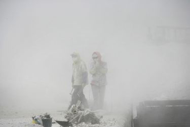 Des ouvriers dans le brouillard empoisonné de Wuhai, en Mongolie-Intérieure. La ville aux 400 usines est la plus polluée de Chine. Aux alentours, tous les arbres sont calcinés. 