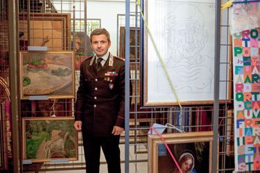 Le major Antonio Coppola dans les réserves du siège des carabiniers, à Rome. A sa droite, « La nature morte au petit chien », de Gauguin, et « La femme aux deux fauteuils » de Bonnard, volés en 1970 et retrouvés en avril dernier. 