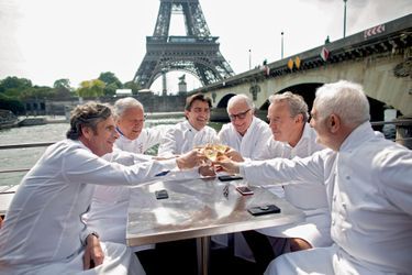 Sur la péniche du restaurant Ducasse-sur-Seine, champagne pour le clan des étoilés qui partageront avec leurs invités les « bouchées » de leur menu, le temps d’une croisière.