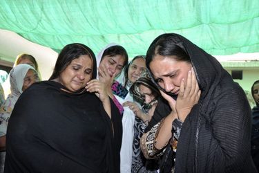 Les proches de Rashid Rehman pleurent près de son corps, à Multan.