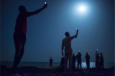 African migrants on the shore of Djibouti city at night-Migrants africains, la nuit, sur la baie de Djibouti 