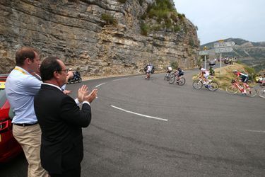 Sur le bord de la route, entre Rodez et Mende le 18 juillet 2015, François Hollande, accompagné de Christian Prudhomme, attend le peloton parmi les spectateurs.