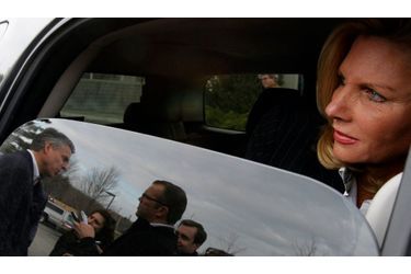 Jon Huntsman, à gauche, répond aux questions de journalistes, tandis que sa femme Mary-Jane l’attend dans la voiture. L’ancien gouverneur de l’Utah se prépare au caucus républicain du New Hampshire, et brigue la candidature républicaine à l’élection présidentielle.