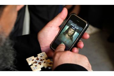 A Alexandrie, ce prêtre copte se sert de son iPhone avant de procéder à une prière pour les proches des victimes qui ont péri après l'attaque à la bombe. 21 personnes sont décédées samedi devant une église de la ville. D’après une source, sept personnes seraient interrogées.