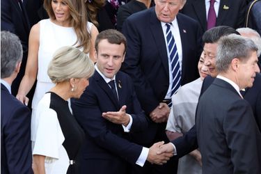 Le président chinois Xi Jinping et sa femme Peng Liyuan saluent Brigitte et Emmanuel Macron.