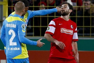 Discussion houleuse entre deux joueurs du FC Cologne et un autre du SC Freiburg, en coupe d&#039;Allemagne. 