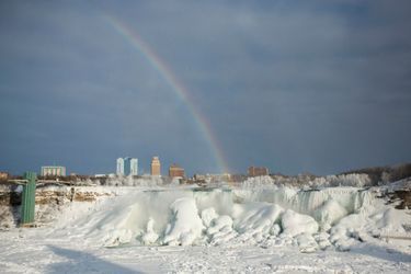A rainbow appears over the partially frozen American Falls in sub freezing temperatures in Niagara Falls Ontario