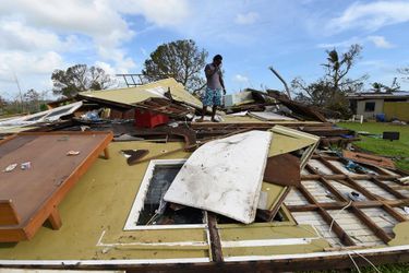 Local resident Adrian Banga looks at his home destroyed by Cyclone Pam in Port Vila, the capital city of the Pacific island nation of Vanuatu