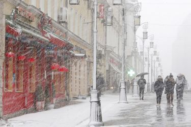 People walk during a heavy snowfall in central Moscow