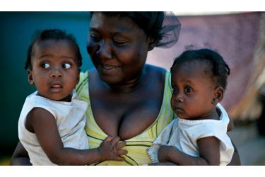 Cette maman souriante vit avec ses jumeaux dans un camp de rescapés de Port-au-Prince. Leur domicile a été détruit dans le séisme du 12 janvier, mais la petite famille y a survécu, c'est l'essentiel.