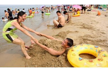 Cette femme profite du beau temps avec son mari, sur la plage de Yantai, dans la province de Shandong en Chine.