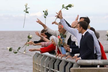 Emmanuel et Brigitte Macron ont jeté des roses dans le fleuve, aux côtés de familles de disparus, jeudi au parc de la Mémoire à Buenos Aires.