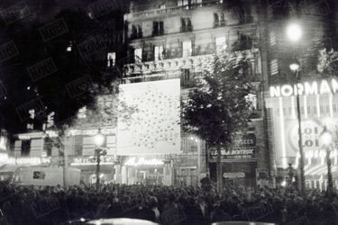 Les résultats du référendum sur la constitution de la Vème République, donnés sur une carte géante de la France, dressée sur une façade de l'avenue des Champs-Elysées, à Paris, dans la nuit du 28 au 29 septembre 1958. 