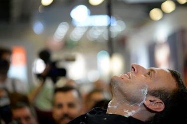 Emmanuel Macron se fait raser la barbe au Salon de la coiffure.