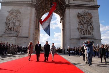 Emmanuel Macron et Xi Jinping, accompagnés de leurs épouses, lors de la cérémonie officielle à l'Arc de Triomphe. 