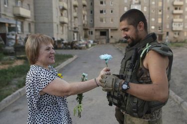 Une femme offre une fleur à un soldat ukrainien à Avdiivka, dans la région du Donetsk, le 24 août 2015, pour célébrer l&#039;indépendance ukrainienne.