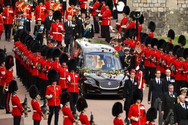 Des grenadiers escortent le cercueil alors que la procession suivant le cercueil de la reine Elizabeth II, à bord du corbillard d'État, se déplace à l'intérieur du château de Windsor le 19 septembre 2022, avant le service d'engagement de la reine Elizabeth II.