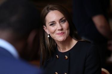 Kate Middleton, souriante, échange avec les bénévoles qui ont participé aux funérailles de la reine Elizabeth II, à Windsor, le 22 septembre 2022. 
