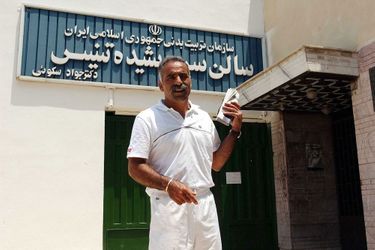 Mansour Bahrami in 2003, back in Iran, poses in front of the sports center in Tehran.