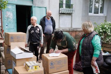 Signing a receipt after delivery of World Food Program parcels.