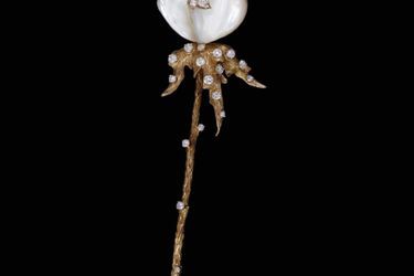 This pink gold, diamond, sapphire, and mother-of-pearl brooch by Beatrice de Plainvale and Pierre Sterlet from 1976 with an engraved plaque (below) colored by Redouté is from the 19th century.
