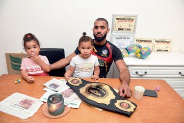 With his two daughters, Inaya (left) and Lyna, his belt and his championship titles, on July 29, at his home in Nemours, where he received us.