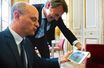 Jean-Michel Blanquer et François Baroin regardent une photo d'eux enfants, le 11 juillet, dans le bureau du ministre.