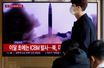 Un homme passe devant une télévision diffusant un reportage, sur la Corée du Nord tirant un missile balistique au large de sa côte est, à Séoul, Corée du Sud, le 17 novembre 2022.